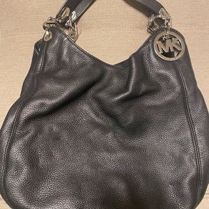 Michael Kors black leather hobo three pocket purse.